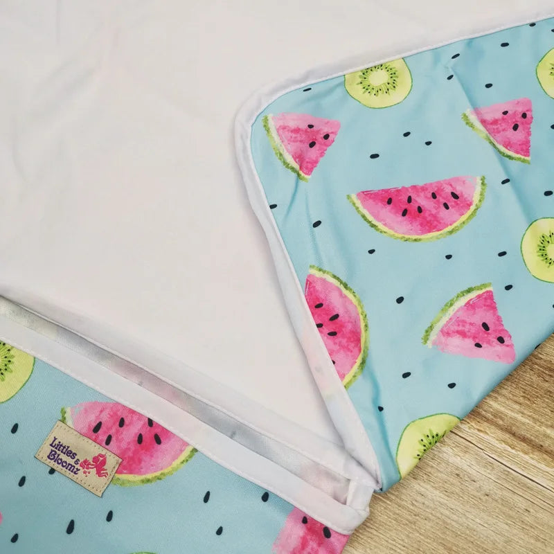Portable waterproof baby changing mat folded for travel | Baby lying on foldable washable changing mat | Compact baby play mat with waterproof surface | Lightweight diaper changing mat for on-the-go use | Soft and hygienic baby changing pad for daily use | Travel baby mat with snap closure and easy fold | Machine washable baby changing mat on wooden floor | Modern baby play mat for indoor and outdoor use | Foldable diaper changing pad inside diaper bag | Waterproof changing mat for babies in neutral design