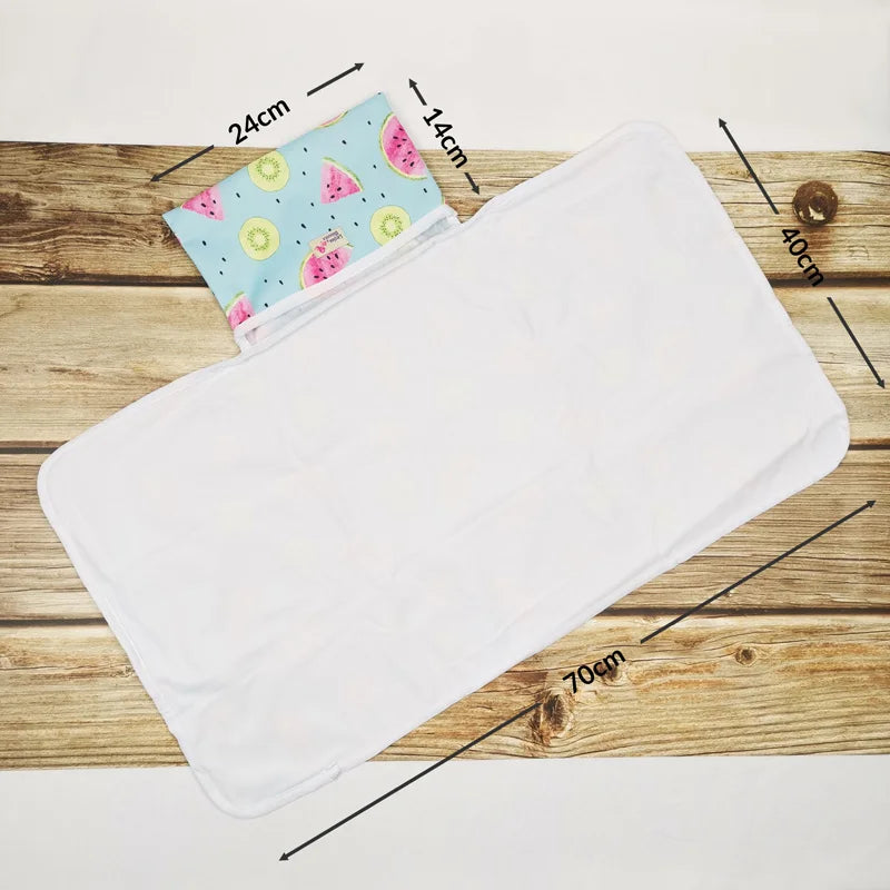 Portable waterproof baby changing mat folded for travel | Baby lying on foldable washable changing mat | Compact baby play mat with waterproof surface | Lightweight diaper changing mat for on-the-go use | Soft and hygienic baby changing pad for daily use | Travel baby mat with snap closure and easy fold | Machine washable baby changing mat on wooden floor | Modern baby play mat for indoor and outdoor use | Foldable diaper changing pad inside diaper bag | Waterproof changing mat for babies in neutral design